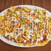 Nachos Especiales · With choice of meat, cheese, beans, jalapenos, sour cream and tomato.
