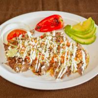 Huarache · Served with beans, lettuce, tomato, cheese, sour cream, onions, red or green salsa and your ...