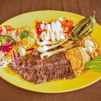 Carne a La Tampiquena · Served with 2 enchiladas, skirt steak, fried onions, jalapenos and one quesadilla.