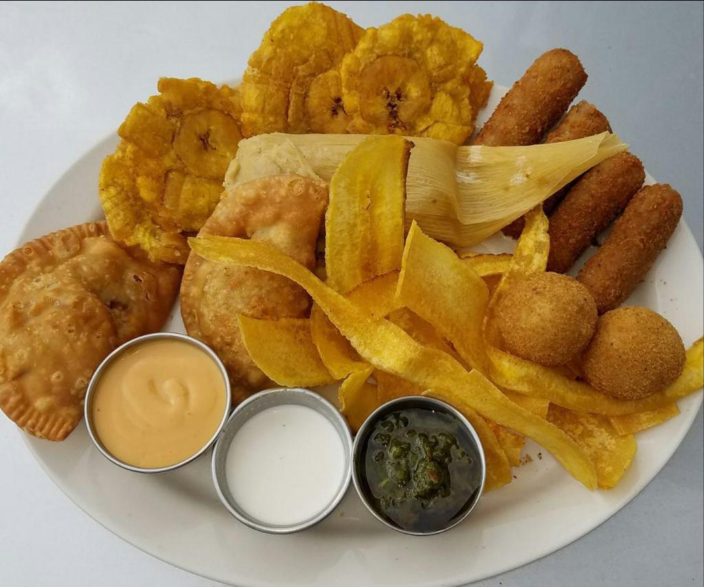 Bandeja 1492 · Cuban sampler plate. 4 ham croquettes, 2 stuffed potatoes, 1 Cuban tamale, 2 empanadas, 4 fried green plantains and plantain chips.