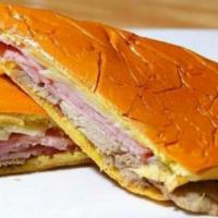 Media Noche  · Sweet bread, smoked ham, roast pork, Swiss cheese, pickles and mustard. With a slight bit of...