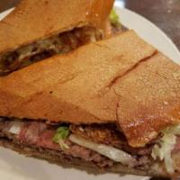 Sandwich de Bistec  · Grilled steak, grilled onions, lettuce and tomato. With a slight bit of mayo and butter.