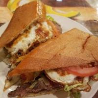 Sandwich de Bistec a Caballo  · Grilled steak, grilled onions, lettuce, tomato and fried eggs sandwich. With a slight bit of...