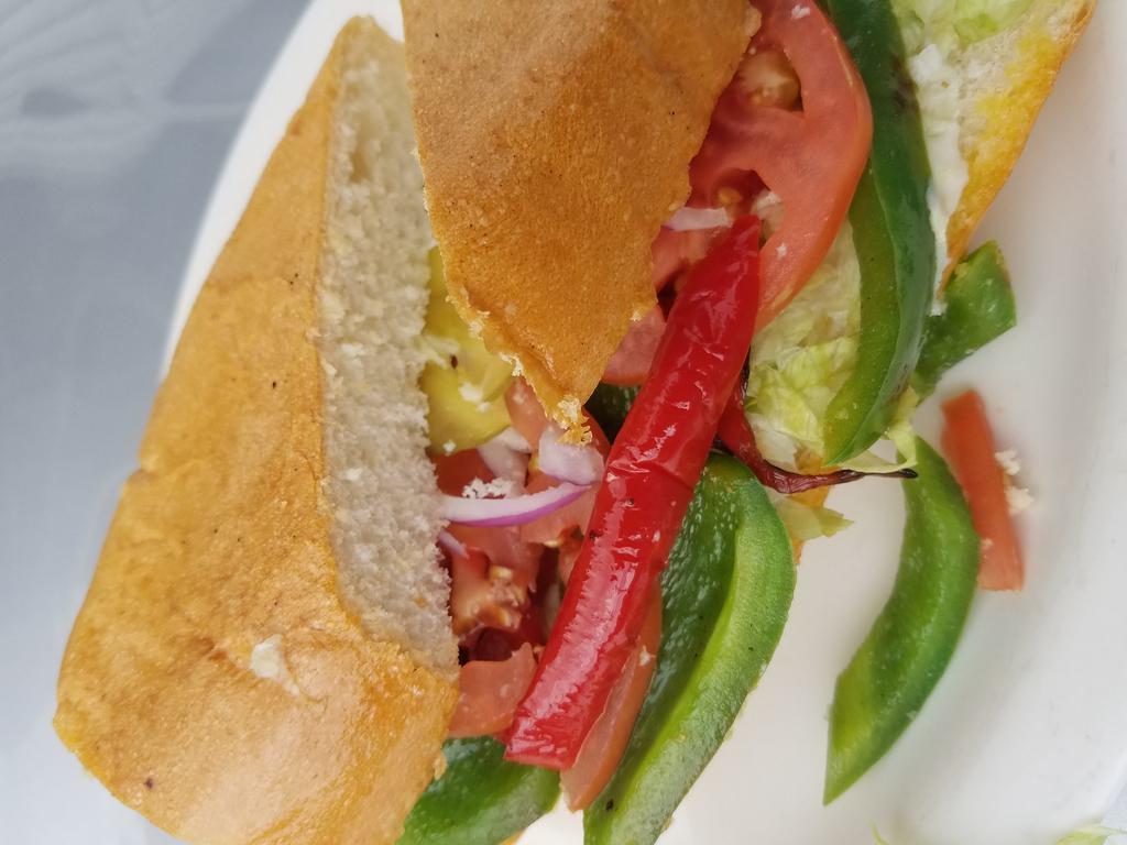Sandwich de Vegetales  · Veggie sandwich with onions, lettuce, tomato, peppers, butter, and mayo. With a slight bit of mayo and butter.