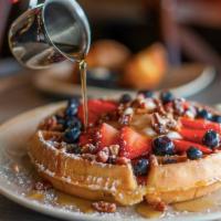 T's Rose Window Waffle · A classic Belgian waffle w/ fresh strawberries + blueberries, Greek-style vanilla yogurt, ca...