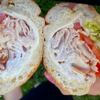 Turkey Breast Hoagie · Turkey breast with mayo, tomato, lettuce, onions and seasoning. Served on a Italian roll.  C...