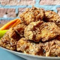 Easy Nuggets · 8 chicken nuggets dry or tossed in homemade wing sauce. Served with carrots, pickle spear, s...