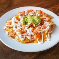 Nachos Supreme · Corn tortilla chips topped with a blend of melted Jack and cheddar cheese choice of beans an...