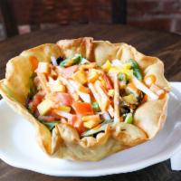 Taco Salad · Crispy taco shell bowl, Romaine lettuce, mesclun, mango, black beans, carrots, pico de gallo...