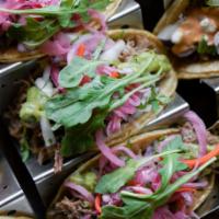 Tacos  · Choice of 3. Mix and match. Served with cilantro and onion. Choice of black beans (vegetaria...