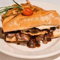 Sliced Steak Sandwich · With a mushroom demi-glaze. Served with french fries and onion strings.