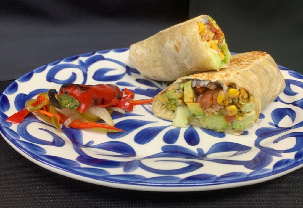 Veggie Burrito · Rainbow cauliflower, roasted corn, black beans, cilantro rice, pico de gallo, fresh avocado, red enchilada sauce, oaxacan and Monterey Jack cheese wrapped in a warm flour tortilla. Vegetarian. Vegan.