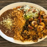 Mixed Fajitas Platillo · Shrimp, chicken and steak sautéed with bell pepper and onions with a side of rice, beans, pi...
