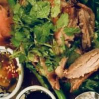 12. Sizzling Duck · Tender young duckling well seasoned and delicately roasted, served over a bed of fresh Chine...