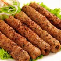 TA6. Lamb Sheekh Kabab · A delicious combination of ground lamb mix with onion mint and spice and rolled over skewer ...