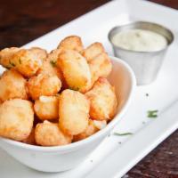 Wisconsin Fried White Cheddar Cheese Curds · Avocado ranch dipping sauce.