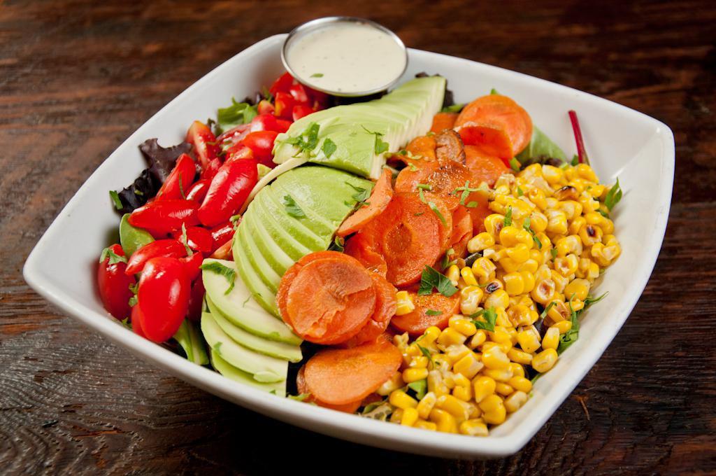 Rainbow Vegetable Bowl · Avocado, teardrop tomatoes, charred corn, honey roasted carrots and jalapeno ranch dressing served on the side.
