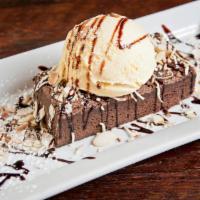 Almond Joy · Homemade brownie topped with vanilla bean ice cream, roasted almonds and toasted coconut.