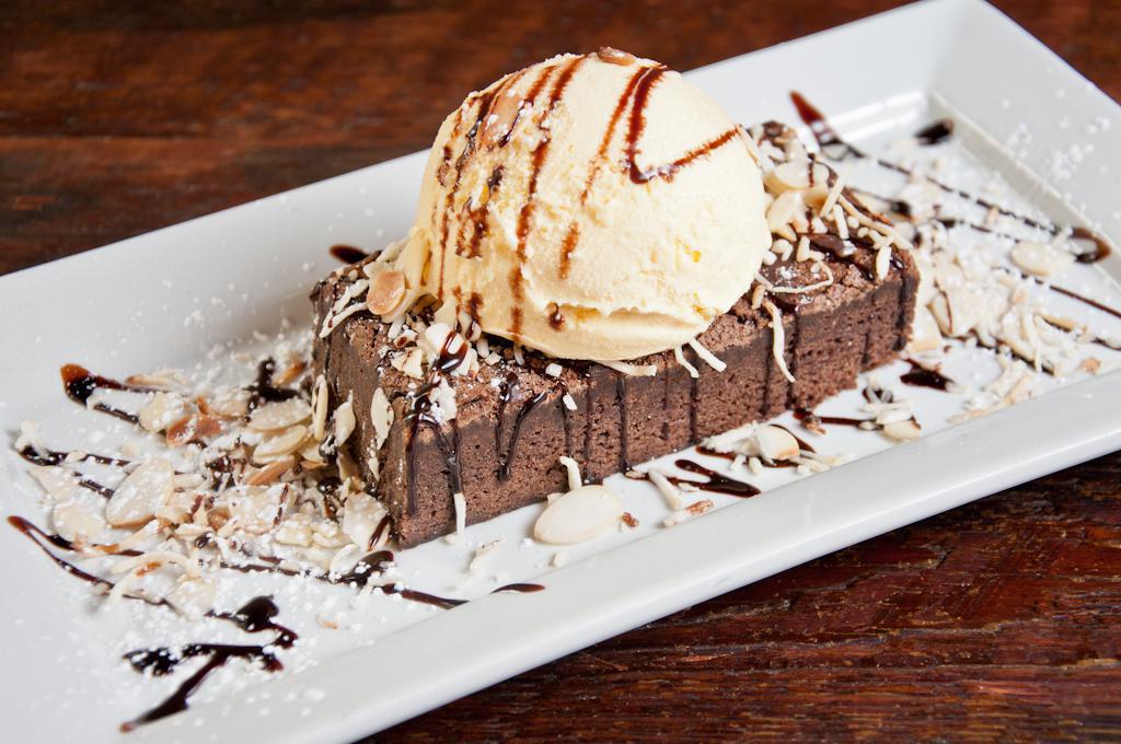 Almond Joy · Homemade brownie topped with vanilla bean ice cream, roasted almonds and toasted coconut.