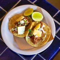 Al Pastor Tacos · spit fired pork, pineapple, onions cilantro (2 per order)