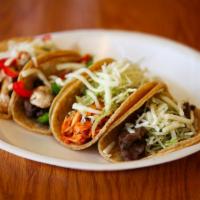 2. Signature Taco Platter Combo · Two tacos. Served with rice and beans.