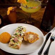 Chimichanga · Deep fried flour tortilla covered with queso sauce. Served with refried beans, Mexican rice ...
