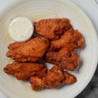 Buffalo Style Chicken Wings · Juicy oven-baked chicken wings served with ranch. Every 6 wings get one ranch.
