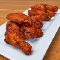 Wings · Baked golden-brown chicken wings served with house-made Buffalo sauce, house-made BBQ sauce,...