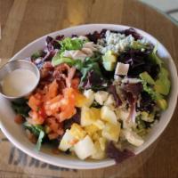 Cobb Salad · Mixed greens, tomato, onion, avocado, egg, ham, chicken, and bacon. Served with bleu and fet...