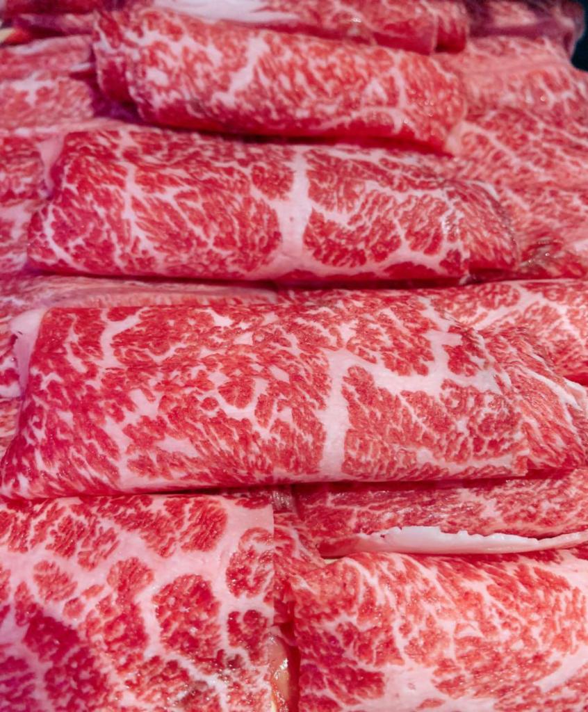 Raw Premium Wagyu Kobe Beef · Thinly freshly sliced marbled Wagyu beef