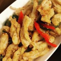 Spicy Squid (GF) · Lightly breaded squid stir fry with bell pepper, onion, garlic and spice over a bed of lettu...