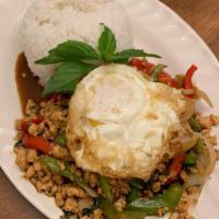 Kra Praw · Mince chicken stir fried with bell peppers, onions, and Thai basil in brown sauce with a fri...
