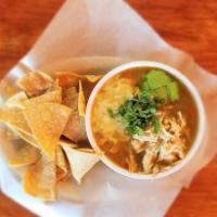 Chicken Tortilla Soup · Topped with avocado slices, tortilla chips and cheese.