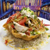 Grilled Chicken Taco salad · A Crispy Flour Tortilla bowl on a bed of Rice, filled with slices of grilled chicken, choice...