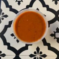 Chipotle Salsa · Spicy salsa made with tomatoes, garlic, roasted chile de arbol, chipotle peppers and seasoni...