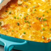Enchilada Casserole · Layers of Corn Tortilla, Roasted Corn and Peppers and Enchilada sauce. Served with crema and...