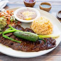 10 oz. Carne Asada · Lean skirt steak lightly seasoned and charbroiled to perfection. Served with guacamole, pico...