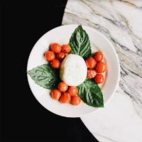 Burrata con pomodorini · Fresh mozzarella ball filled with buffalo milk cream, cherry tomatoes, extra virgin olive oi...