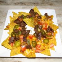 Steak Nachos · Made to order tortilla chips covered in nacho cheese, jalapenos, diced tomatoes, and juicy h...