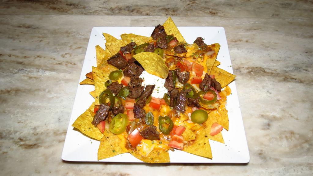 Steak Nachos · Made to order tortilla chips covered in nacho cheese, jalapenos, diced tomatoes, and juicy hanger steak. Top it off with sour cream, Monterey jack, and cheddar cheese.