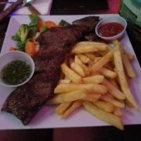 10 oz. Tropix Skirt Steak · Delicious center cut skirt steak served with french fries and sauteed vegetables with a home...