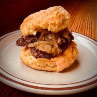 The Essential · Biscuit sandwich topped with marinated steak ,grilled onions and house made red pepper aoili.