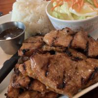 BBQ Chicken · Grilled chicken thigh served with rice and salad.