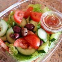 Green Salad · Romaine, tomatoes, cucumbers, carrots, red cabbage, olives dressed with red wine vinegar and...
