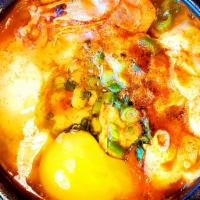 4. Soon Dubu Chigae 순두부 찌개 · Soft tofu, egg, mushroom and choice of seafood, pork or beef prepared in spicy soup.