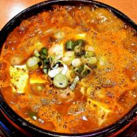 9. Kimchi Chigae 김치찌개 · Kimchi stew a thick stew made from kimchi simmered with onion and sliced pork.