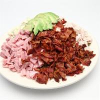 Cobb Salad · Tossed greens, tomatoes, cucumbers, olives, avocado, bacon, sliced egg, blue cheese, red oni...