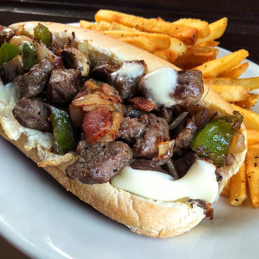 Hand Cut Steak and Cheese Sub · Seasoned steak served in a sub roll with American cheese. Add bacon, peppers, onions, mushrooms for an additional charge.