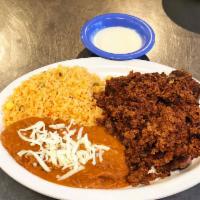 T-Bone con Chorizo · T-bone steak and chorizo topped with cheese sauce. Served with rice and beans. 