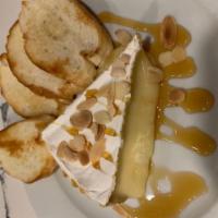Baked Brie · Warm brie, sliced almonds, honey, rustic bread. 